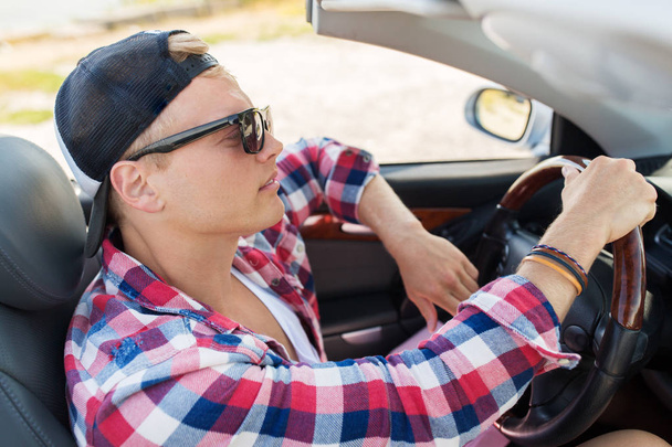 happy young man driving convertible car - Foto, Imagen