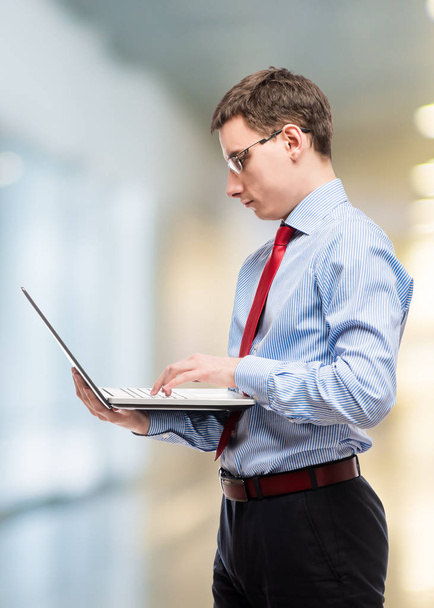 Vertical portrait of a chief accountant in glasses with a laptop - Foto, imagen