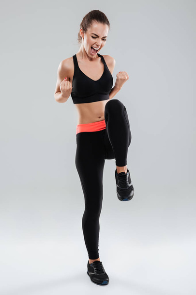 Full length image of So happy screaming fitness woman - Foto, Bild