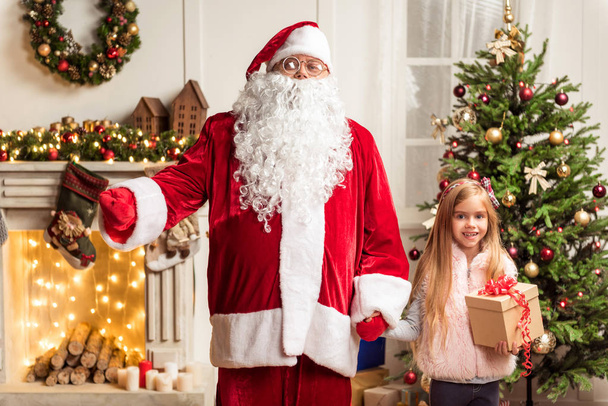 Cheerful kid celebrating winter holiday with Father Frost - Photo, Image