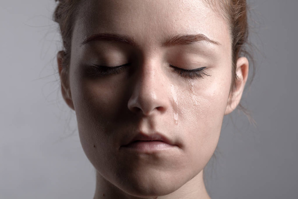 Mulher chorando com os olhos fechados
 - Foto, Imagem