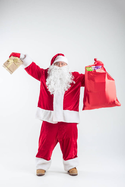 Excited senior Santa holding many presents - Foto, immagini