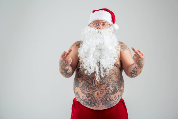 Brutal male fatso in Santa costume gesturing negatively - Fotó, kép