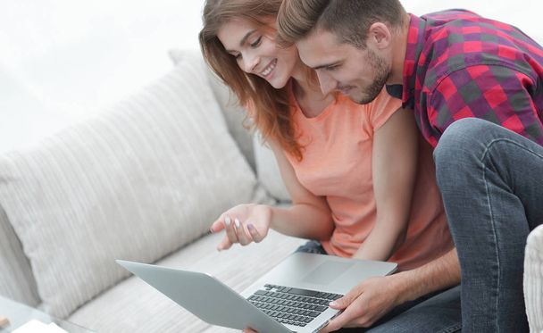 young couple watching videos on laptop - Fotó, kép