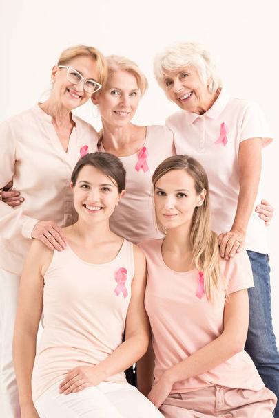 Women in pink shirts and pink ribbons - 写真・画像