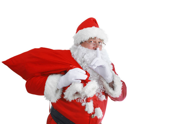 Real Santa Claus carrying big bag full of gifts, isolated on white background - Photo, Image