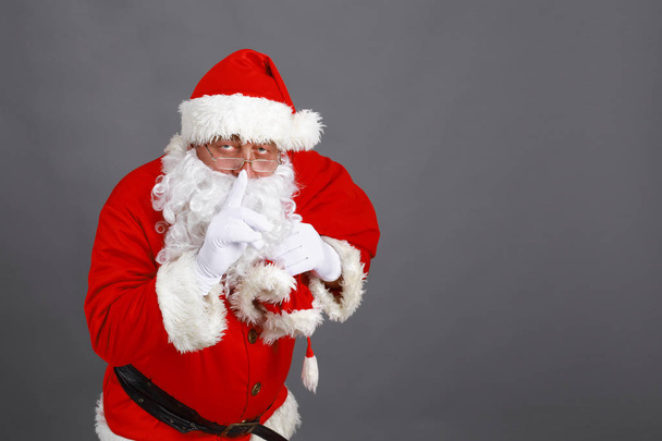 Real Santa Claus carrying big bag full of gifts, isolated on white background - Фото, зображення