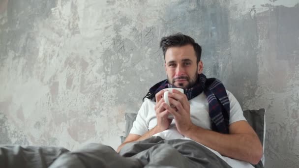 Ill gentleman warming up with tea and scarf - Materiał filmowy, wideo