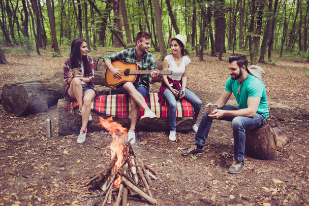 Great weekend together. Fire place, four cheerful serene tourist - Photo, Image