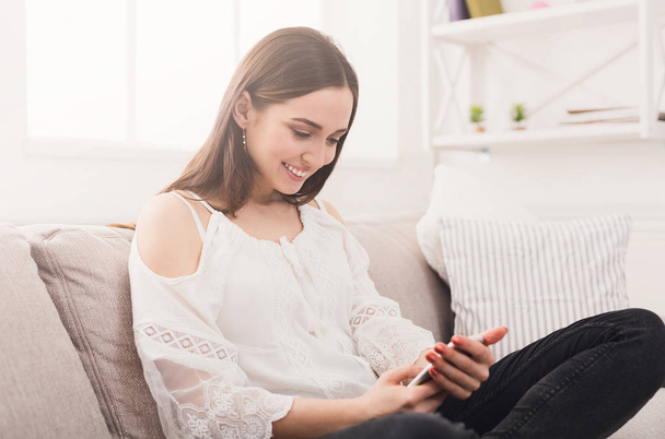 Happy girl at home messaging online - Photo, Image