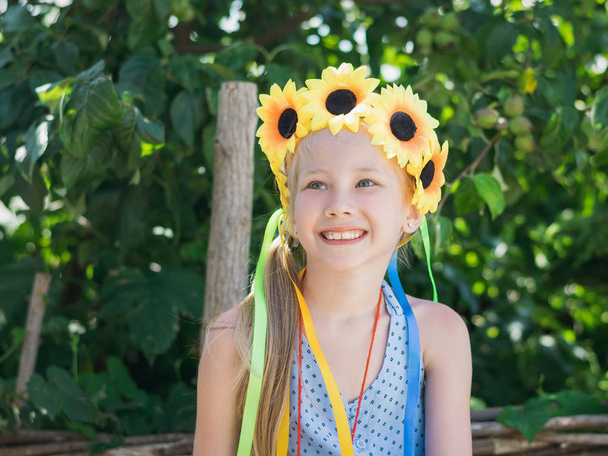 Портрет красивої дівчини з квітами соняшників на голові
. - Фото, зображення