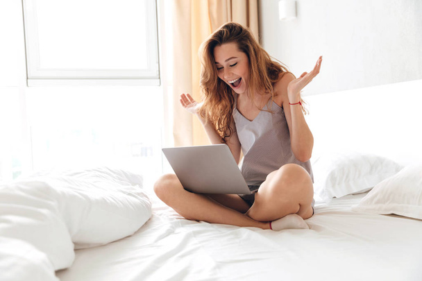 Happy woman using laptop in the morning - Zdjęcie, obraz
