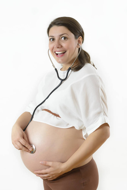 Pregnant Woman Listening her Baby - Foto, Imagen