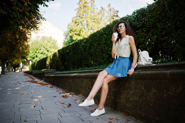 Curly stylish girl wear on blue jeans skirt, blouse and glasses  - Foto, Imagem