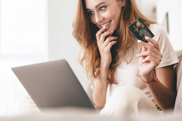 Cropped picture of lady using laptop computer holding credit card. - Foto, afbeelding