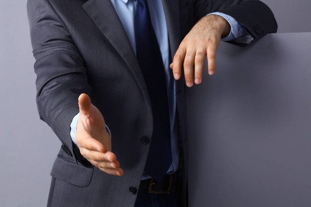 Man wearing a suit offering to shake hands - Fotó, kép