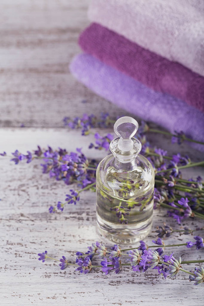 Bottle of essential oil and fresh lavender flowers - Photo, Image