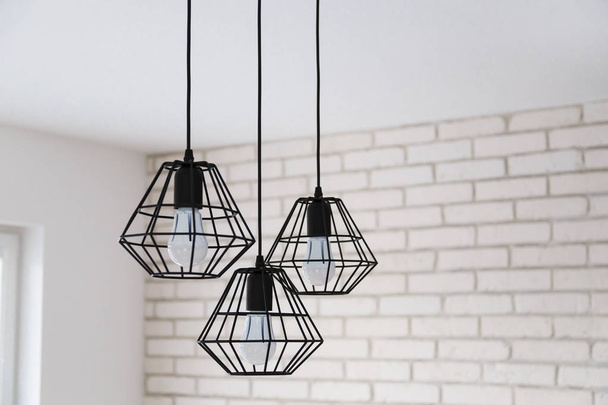 A modern loft chandelier made of black wire in a stylish white interior - Valokuva, kuva