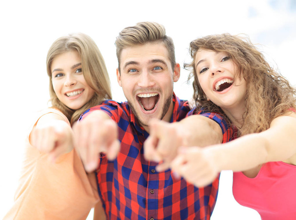 closeup of three happy young people showing hands forward - Photo, image