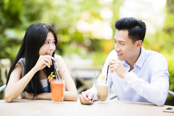 Happy young couple in restaurant enjoying drink - Photo, Image
