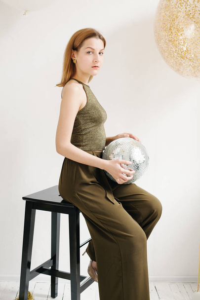 beautiful woman holding disco ball  - Valokuva, kuva