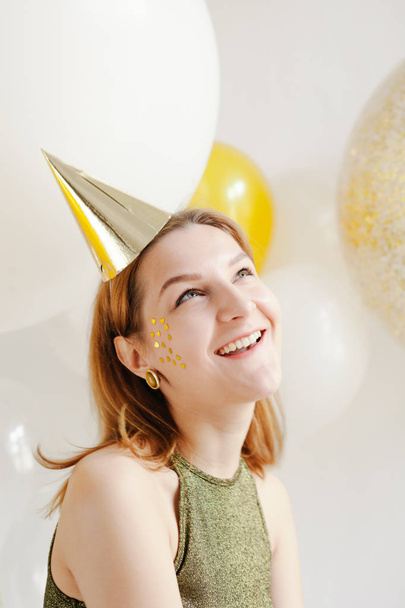 woman in celebratory cap fooling around  - Φωτογραφία, εικόνα