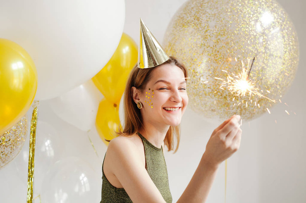 Young woman in celebratory cap  - Фото, зображення