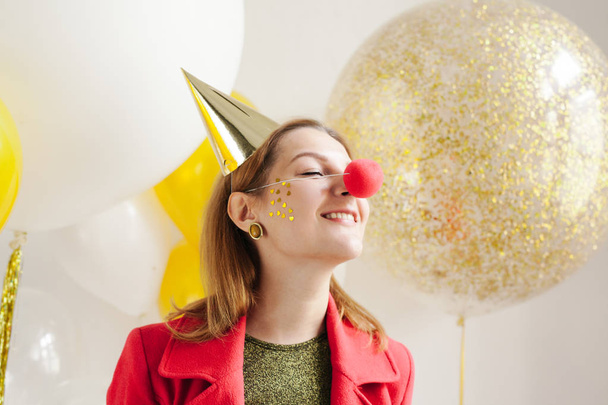 smiling woman with red clown nose  - Φωτογραφία, εικόνα