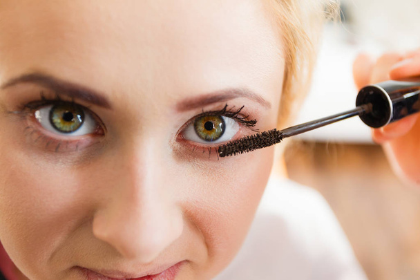 Woman getting eyelashes makeup done - Fotoğraf, Görsel