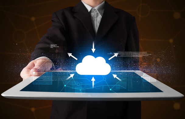 Businessman holding tablet with cloud icon - Foto, imagen