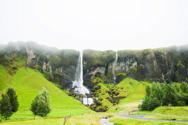 Waterfall in the mountains, southern Iceland.  - Фото, изображение