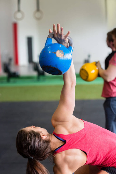 Woman Exercising With Kettlebell In Gym - Фото, зображення