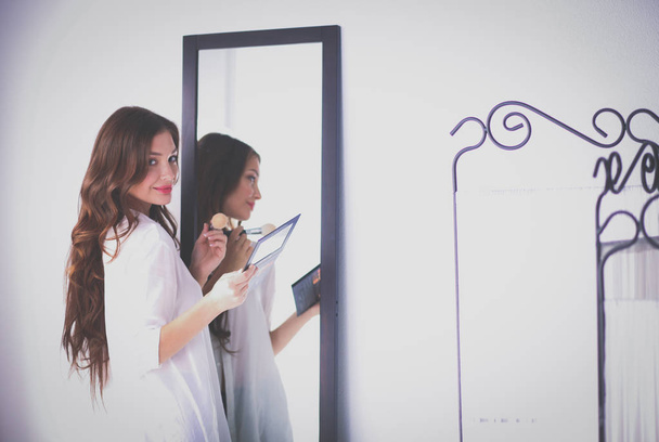 Young woman looking herself reflection in mirror at home. Young woman. - Foto, Imagen