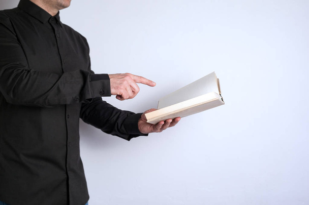 Free space for text, marketing education and business information. Man with a book on white background - Photo, Image