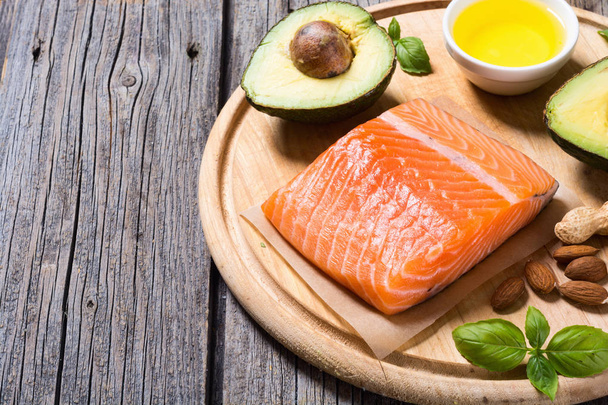 Healthy food vegetables , nuts and salmon  - Фото, зображення