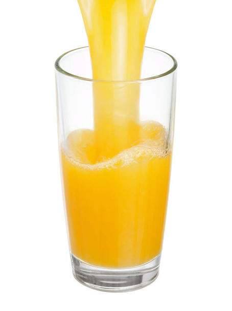 Fresh juice is poured into a glass - Photo, Image