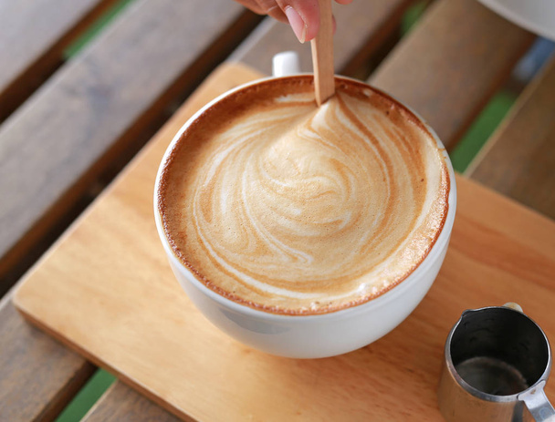Hot latte coffee coffee on wooden table. - 写真・画像