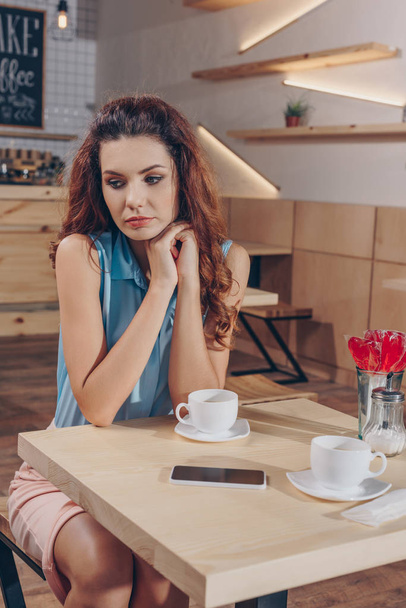 woman sitting at table in cafe - Photo, Image