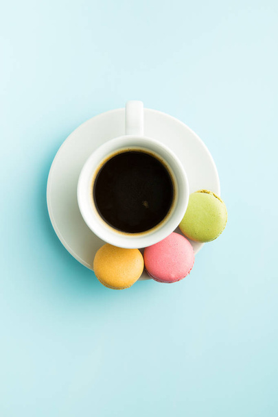 Tasty sweet macarons and coffee cup. - Foto, Imagem