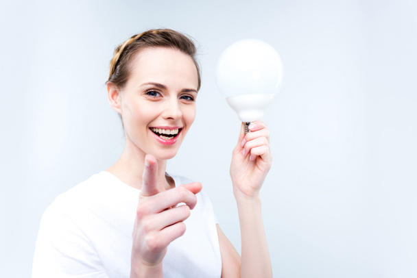 woman with light bulb - Фото, изображение