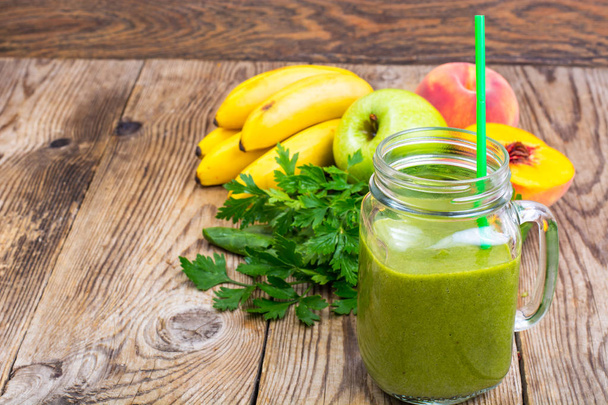 Freshly blended green  smoothie in glass jar on wooden background - Zdjęcie, obraz