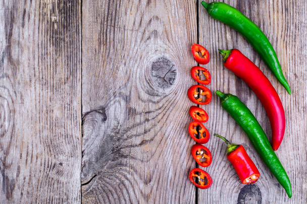 Hot pepper on wooden table - Foto, imagen