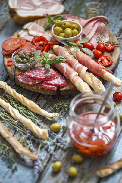 Italian food, prosciutto, grissini, smoked sausage, ham, olives, - Foto, imagen