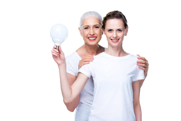adult daughter and mother with light bulb - Fotoğraf, Görsel