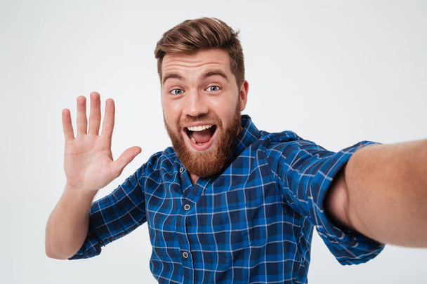 Happy bearded man making selfie and giving five at camera - Foto, imagen