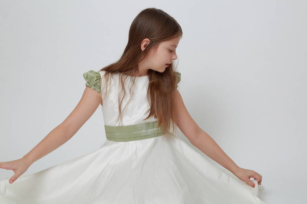 Gorgeous teen girl in a dress posing for a studio portrait - Fotografie, Obrázek