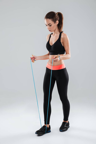Full length image of a young fitness woman doing exercise - Photo, Image