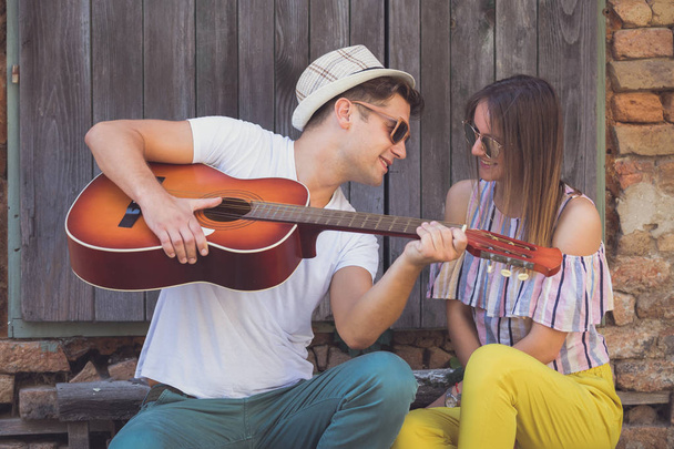 Young couple with acoustic guitar - Fotoğraf, Görsel
