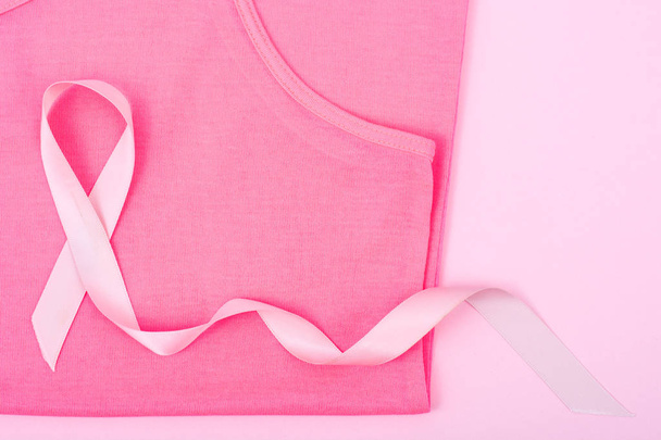 Healthcare and medicine  symbol - pink breast cancer awareness ribbon on female shirt - Фото, изображение