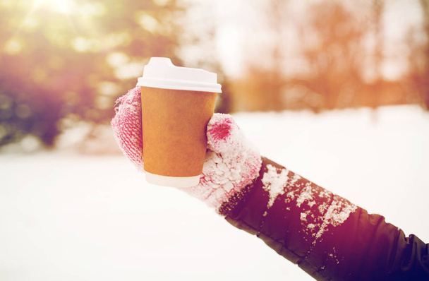 close up of hand with coffee outdoors in winter - Foto, Bild